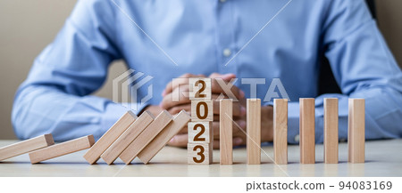 Businessman with  2023 wooden Blocks. Business, Risk Management, Insurance, Resolution, strategy, solution, goal, New Year New You and happy holiday concepts 94083169