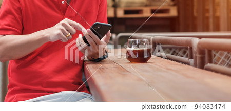 Casual Businessman holding and using smartphone for sms messages, young man typing touchscreen mobile phone in coffee cafe or modern office. lifestyle, technology, Social media and network concept 94083474