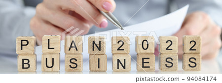 Person is planning a business plan for 2022 closeup Person is planning a business plan for 2022 closeup 94084174