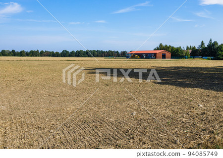 Storage plant, tractors, and agricultural industry buildings. Kaunas, Lithuania, 16 August 2022 Storage plant, tractors, and agricultural industry buildings. Kaunas, Lithuania, 16 August 2022 94085749