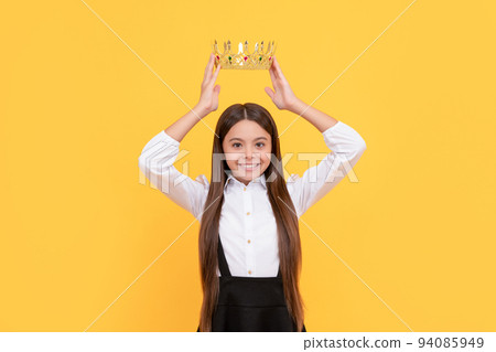 happy selfish teen girl in school uniform wear princess crown, selfishness 94085949