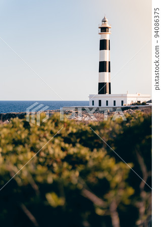 Beautiful blue white lighthouse on the Spanish island of Menorca Beautiful blue white lighthouse on the Spanish island of Menorca 94086375