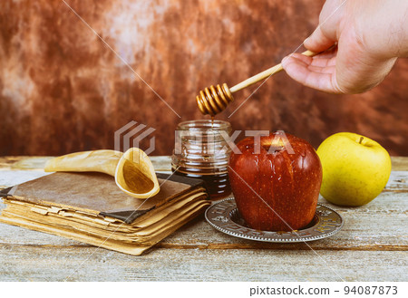 Traditionally, apples, honey, pomegranates, and the sound of shofar are associated with the Jewish New Year holiday of Rosh Hashanah Traditionally, apples, honey, pomegranates, and the sound of shofar are associated with the Jewish New Year holiday of Rosh Hashanah 94087873