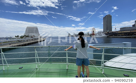 Rear view of children sisters on a sightseeing boat in Kobe port in summer 94090259