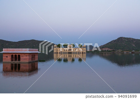 Jal Mahal, a water palace floating on Lake Man Sagar in Jaipur, India at sunset Jal Mahal, a water palace floating on Lake Man Sagar in Jaipur, India at sunset 94091699