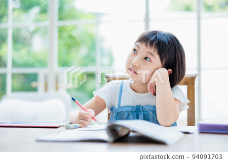 Elementary school girl thinking about answering questions 94091703