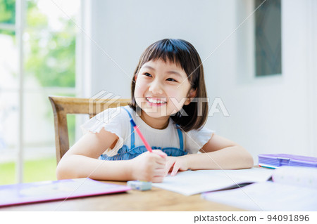 Elementary school girl studying at home Elementary school girl studying at home 94091896