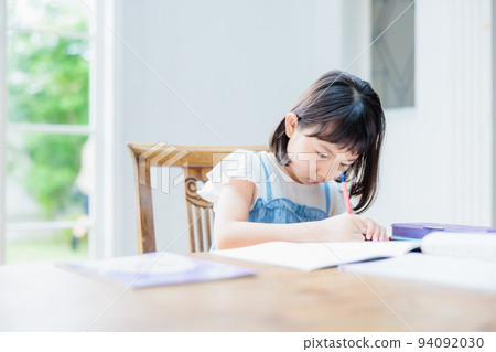 Elementary school girl studying at home 94092030