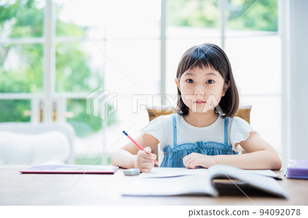 Elementary school girl studying at home 94092078