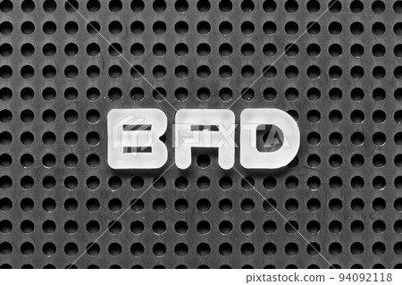 White alphabet letter in word bad on black pegboard background White alphabet letter in word bad on black pegboard background 94092118