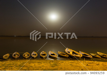Boat and moon floating on the holy Ganges river in Varanasi, India at night Boat and moon floating on the holy Ganges river in Varanasi, India at night 94093259