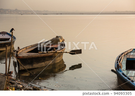 Boats floating on the Ganges River early in the morning in Varanasi, India Boats floating on the Ganges River early in the morning in Varanasi, India 94093305