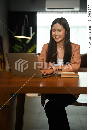 Beautiful young start up businesswoman working online with laptop at home office 94093905