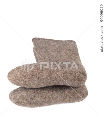 Valenki - winter shoes, felted wool boots on a white background. 94096039
