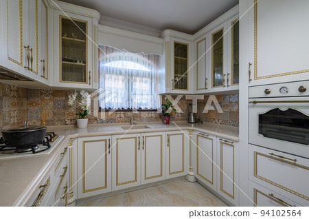 White classic cozy kitchen and dining room in city house White classic cozy kitchen and dining room in city house 94102564