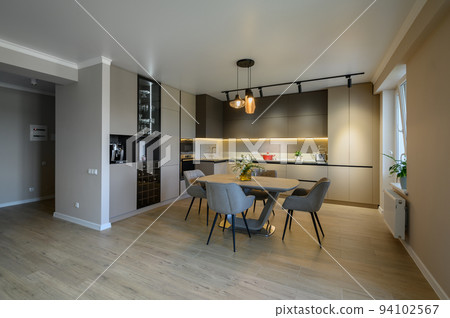 Large modern grey luxurious kitchen and dining room in studio apartment Large modern grey luxurious kitchen and dining room in studio apartment 94102567