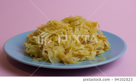 Stewed white cabbage on a plate. A dish of Russian cuisine. Garnish in the USSR. Stewed white cabbage on a plate. A dish of Russian cuisine. Garnish in the USSR. 94102823