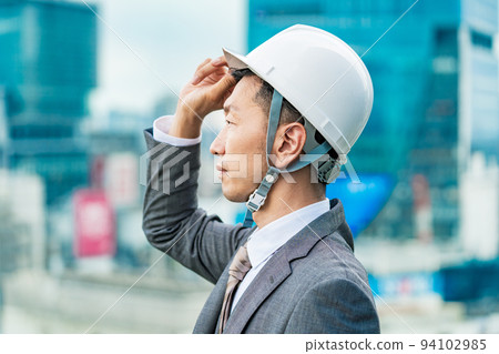 A businessman wearing a helmet 94102985