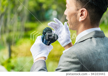 A man making a claim on the street with a microphone 94103441