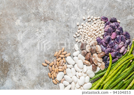 Different varieties of beans on a concrete background. Top view, copy 94104853