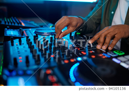 Closeup male hand on sound mixer console Closeup male hand on sound mixer console 94105136