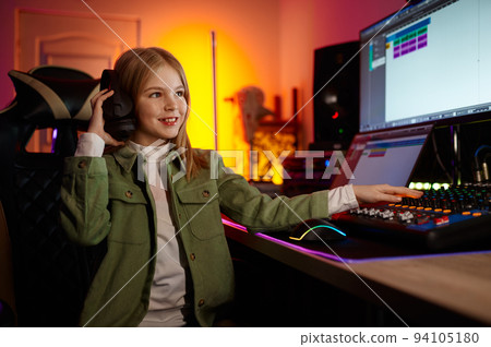 Young audio engineer mixing sound at production house 94105180