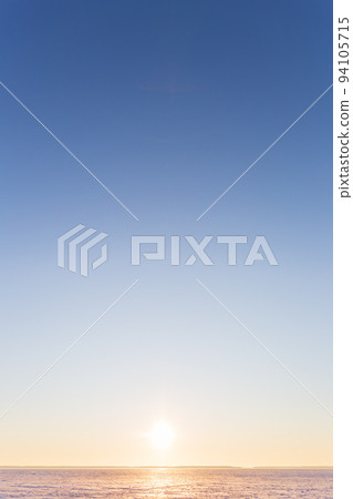 Vertical beautiful landscape, clear blue sky, low horizon, sunrise or sunset. Beauty in nature. Universal natural gradient background. Concept of freedom, tranquility, unity with nature. Copy space. 94105715