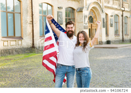 American citizenship is a very precious possession. Bearded man and sensual woman holding american flag on July 4th. American couple celebrating Independence day. Living the American dream 94106724