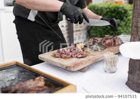 The chef cooks the veal at a plancha The chef cooks the veal at a plancha 94107515