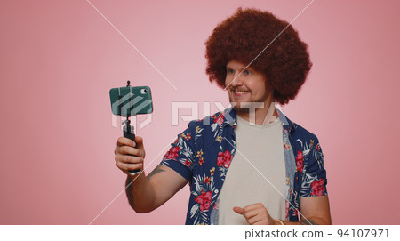 Man blogger take selfie on mobile phone selfie stick communicate video call online with subscribers 94107971