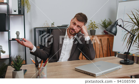 Business man working on laptop loses becoming surprised sudden lottery results bad news fortune loss Business man working on laptop loses becoming surprised sudden lottery results bad news fortune loss 94108590
