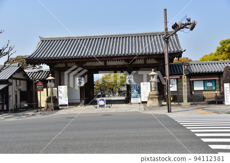 Kyoto City, Kyoto Prefecture, Japan, Toji Temple in spring, with a quaint old gate and the road in front 94112381
