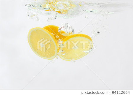 sliced lemon falling in water sliced lemon falling in water 94112664
