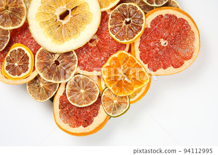 Dried slices of various citrus fruits on white background Dried slices of various citrus fruits on white background 94112995