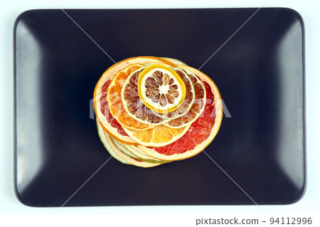 mix different pieces of dried citrus fruit on a plate mix different pieces of dried citrus fruit on a plate 94112996