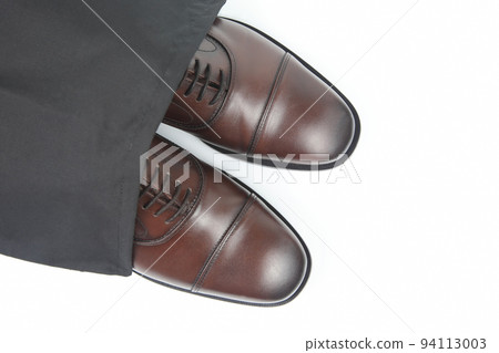 Classic men's brown Oxford shoes in protective black pouch on white background Classic men's brown Oxford shoes in protective black pouch on white background 94113003