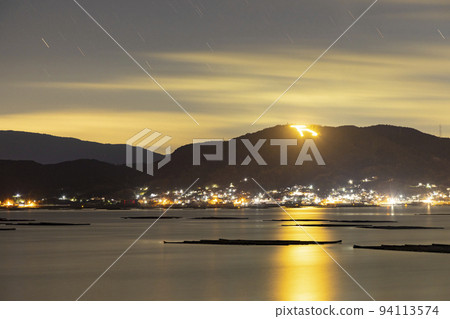A winter starscape in Setouchi, the trail of the stars in the sky lit by the Manyokyo 94113574
