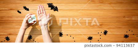 Applying sanitizer gel with Halloween theme 94113637