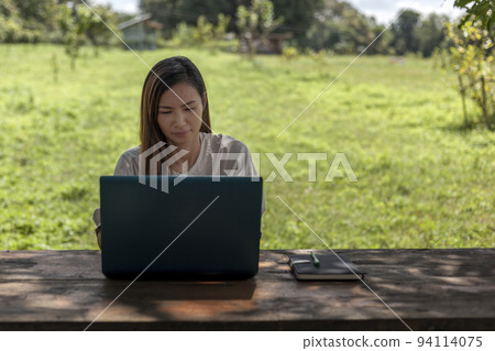 Asian women working with laptops in a shady farm environment Work at home concept 94114075