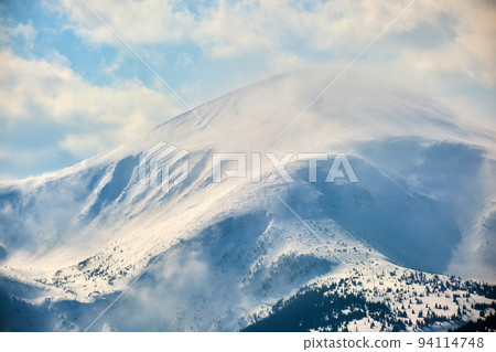 Winter landscape with high mountain hills covered with evergreen pine forest after heavy snowfall on cold wintry day. Winter landscape with high mountain hills covered with evergreen pine forest after heavy snowfall on cold wintry day. 94114748