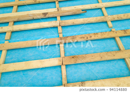 Top down detail of a wooden roof frame on a house under construction. 94114880