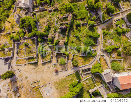 Old city. Sunny view of ruins of citadel in Stari Bar town near Bar city, Montenegro. Drone view Portrait of a disgruntled girl sitting at a cafe table Old city. Sunny view of ruins of citadel in Stari Bar town near Bar city, Montenegro. Drone view Portrait of a disgruntled girl sitting at a cafe table 94114952