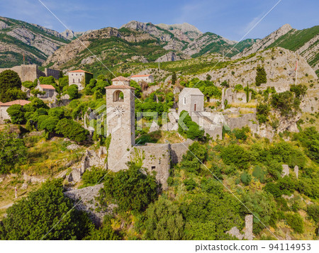 Old city. Sunny view of ruins of citadel in Stari Bar town near Bar city, Montenegro. Drone view Portrait of a disgruntled girl sitting at a cafe table 94114953