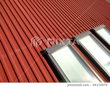 Red tiled house roof with attic windows. Roofing construction, window installation, modern architecture concept. Red tiled house roof with attic windows. Roofing construction, window installation, modern architecture concept. 94114979