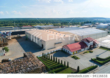 Aerial view of wood processing factory with stacks of lumber at plant manufacturing yard. Aerial view of wood processing factory with stacks of lumber at plant manufacturing yard. 94116638