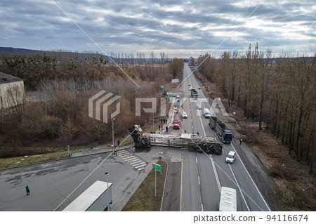 Aerial view of road accident with overturned truck blocking traffic Aerial view of road accident with overturned truck blocking traffic 94116674