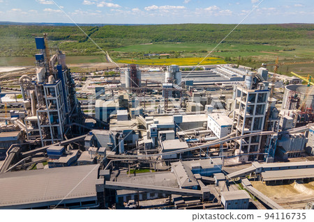 Aerial view of cement factory with high concrete structure and tower crane at industrial production area. Manufacture and global industry concept. 94116735