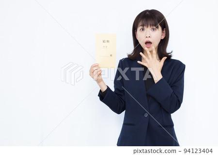 A business woman in her thirties who is surprised with a salary bag A business woman in her thirties who is surprised with a salary bag 94123404