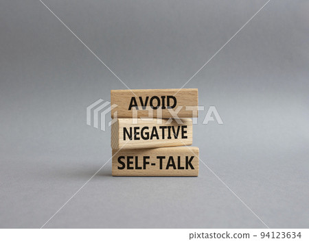 Avoid negative self-talk symbol. Concept words Avoid negative self-talk on wooden blocks. Beautiful grey background. Business and Avoid negative self-talk concept. Copy space. 94123634
