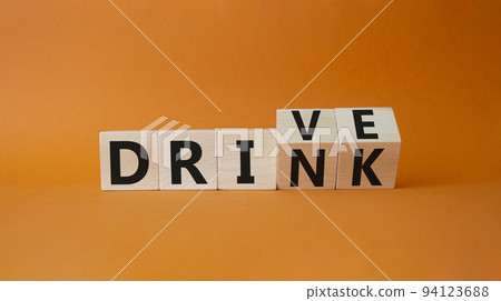 Drive vs drink symbol. Turned cubes with words drink vs drive. Beautiful orange background. Business and Drive vs drink concept. Copy space Drive vs drink symbol. Turned cubes with words drink vs drive. Beautiful orange background. Business and Drive vs drink concept. Copy space 94123688